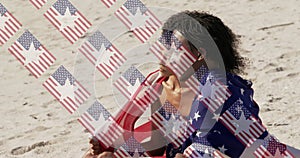 Animation of usa flags over diverse women sitting on beach