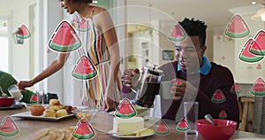 Animation of watermelon slices over diverse couple having breakfast at home