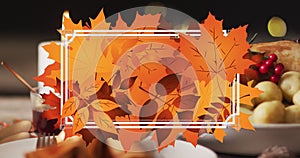 Animation of white frame and autumn leaves over thanksgiving dinner background