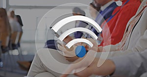 Animation of wifi icons over diverse business people using electronic devices