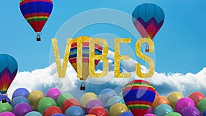 Animation of the word vibes in gold with hot air balloons on blue sky