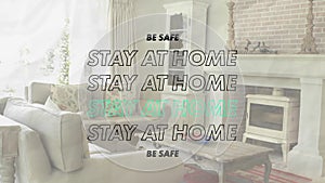 Animation of words Be Safe Stay At Home flashing over an empty living room