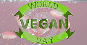 Animation of world vegan day text over fruit falling in water background