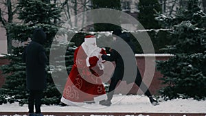 Animator in costume of russian Ded Moroz like a Santa Claus fights with passerby on Central square. Aggressive and angry