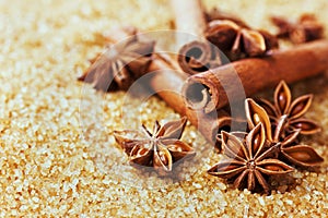 Anise star and cinnamon sticks on brown cane sugar