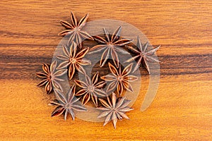 Anise stars on wooden, top view