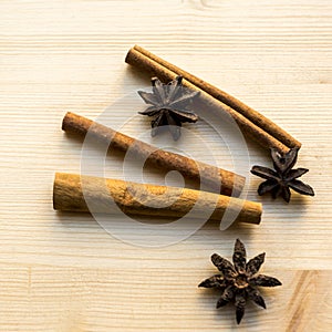 Anise and sticks of cinnamon on wooden background. Spices for coffee, hot tea, mulled wine, punch