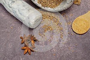 aniseed spice (Pimpinella anisum) in a white marble mortar