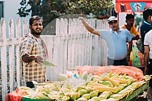 Anjuna, Goa, India. Man Seller Sells Traditional Indian Fried Maize Corn In The Anjuna Market