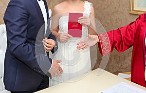 Ankara/Turkey- December 12 2014: Marriage registrar congratulates new couple and gives the family registry to the bride