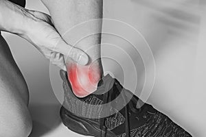 Ankle, joint pain, and tendon problem. Athlete man touching ankle