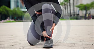 Ankle, pain and woman with injury from sport, outdoor for exercise and workout on street. Orthopedic, accident and shoes