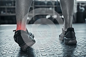 An ankle sprain from one wrong move. Exercise can result in muscle strain. Closeup on foot pain of a bodybuilder in the
