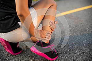 Ankle sprained. Young woman suffering from an ankle injury