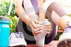 Ankle sprained. Young woman suffering from an ankle injury while exercising and running. Healthcare and sport concept.