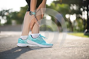 Ankle sprained. Young woman suffering from an ankle injury while exercising and running. Healthcare and sport concept