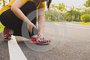 Ankle sprained. Young woman suffering from an ankle injury while jogging and running at the park. Healthcare and sport concept