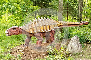 Ankylosaurus dinosaur in a green forest photo