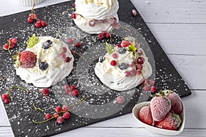 Anna Pavlova cake with currants, blueberries and strawberries photo