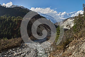 Annapurna Circuit Track- view of the river and Kali Gandaki canyon, on the background Tukuche Peak