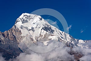 Annapurna South mountain peak with blue sky background