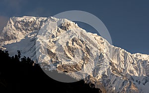 Annapurna South snowcapped mountain summit against blue sky in Annapurna Base Camp Trekking