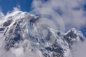 Annapurna South surrounded by rising clouds in the Himalayas photo