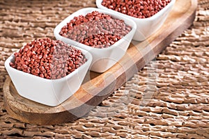 Annatto seeds in the bowls - bixa orellana