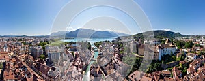 Annecy city center panoramic aerial view with the old town, castle, Thiou river and mountains surrounding the lake, beautiful