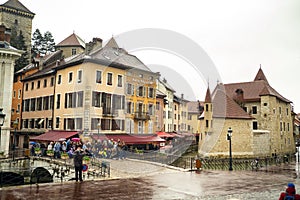 ANNECY, FRANCE-APRIL 3, 2019: The Tioux River embankment in the Old Town, surrounding a medieval palace located in the middle of