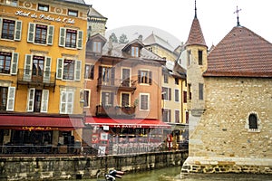 ANNECY, FRANCE-APRIL 3, 2019: The Tioux River embankment in the Old Town, surrounding a medieval palace located in the middle of