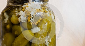 Ð¡anned cucumbers in glass on light background