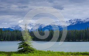 Annette Lake with snow-capped mountains in Jasper National Park.