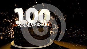 Anniversary 100 greeting card. Chocolate cake decorated with colored dragees with white numbers on a wooden table with fireworks