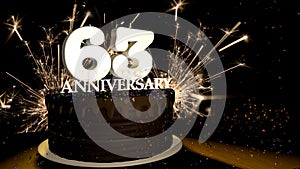 Anniversary 63 greeting card. Chocolate cake decorated with colored dragees with white numbers on a wooden table with fireworks in