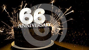 Anniversary 66 greeting card. Chocolate cake decorated with colored dragees with white numbers on a wooden table with fireworks in