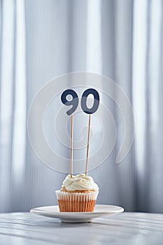 Anniversary or birthday cupcake with number 90 ninety