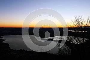 Annone lake at sunset from monte Barro during a clear sky autumn night photo