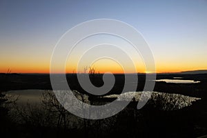 Annone lake at sunset from monte Barro during a clear sky autumn night photo