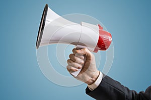Announcement concept. Hand holds megaphone