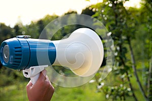 A woman holds a megaphone in her hand