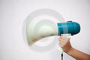 A woman holds a megaphone in her hand