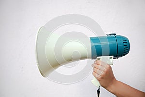 A woman holds a megaphone in her hand