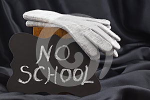 NO SCHOOL sign on chalkboard against black satin warns of cold w photo