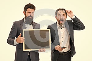 Announcement. party invitation. businessmen use phone, copy space. bearded men hold advertisement blackboard. partners