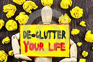 Announcement text showing De-Clutter Your Life. Concept meaning Free Less Chaos Fresh Clean Routine written on Sticky Note Holding
