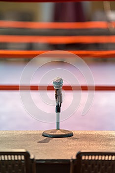 Announcer microphone on table before boxing ring