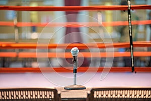 Announcer microphone on table before boxing ring