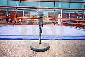 Announcer microphone on table before boxing ring