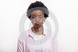 Annoyed afro woman blowing her cheeks